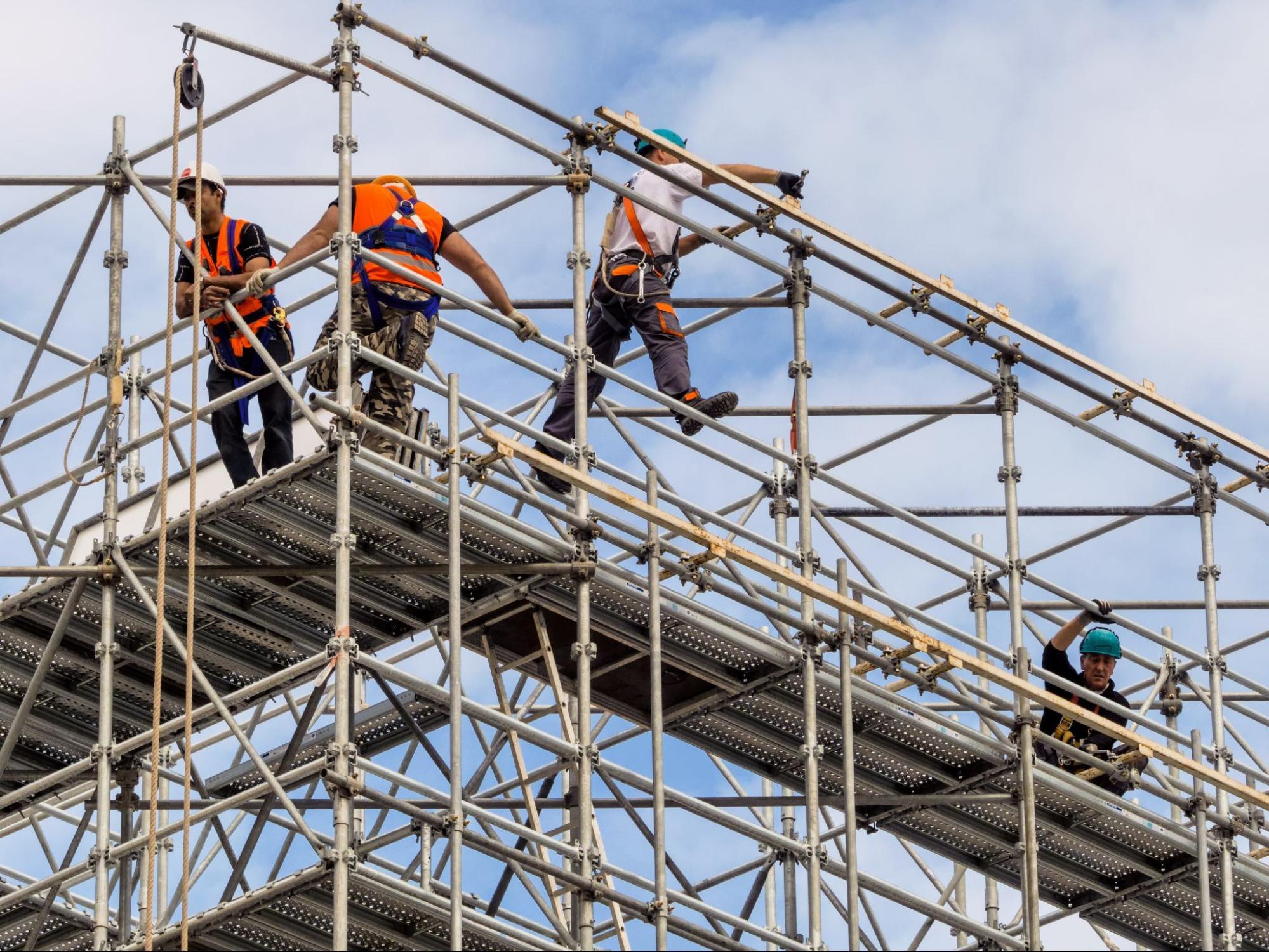 Employees high up on a scaffold